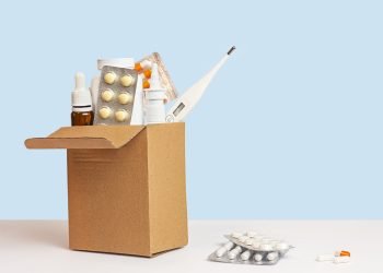 box-with-medicines-blister-with-pills-wooden-table-blue-background